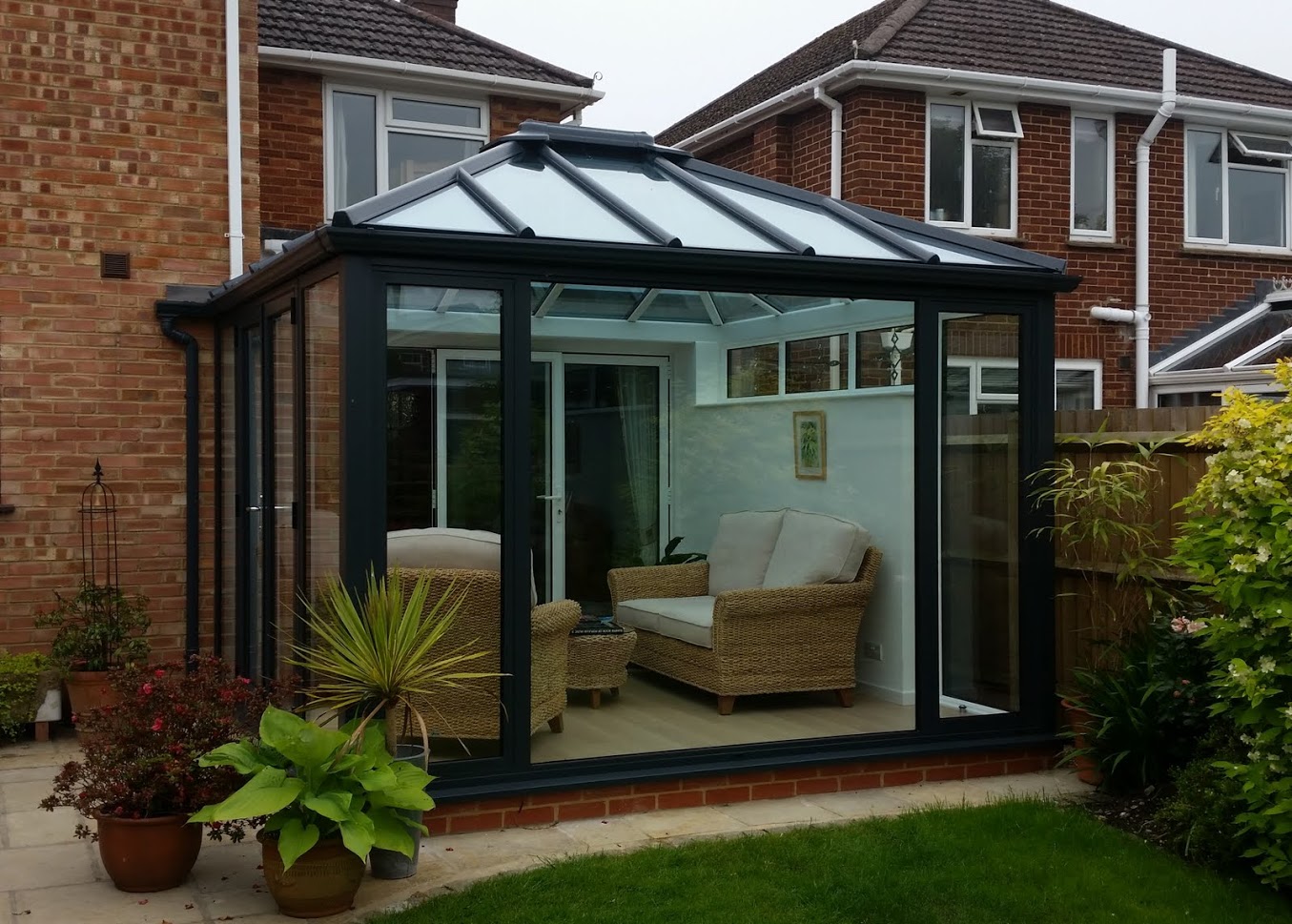 Outside view of a cosy Livin room conservatory design ideal for reading.