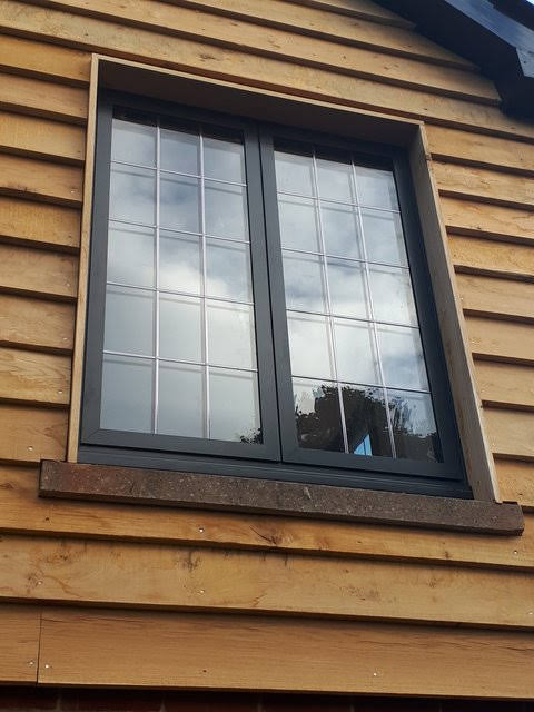 Low angle image of new black aluminium windows.