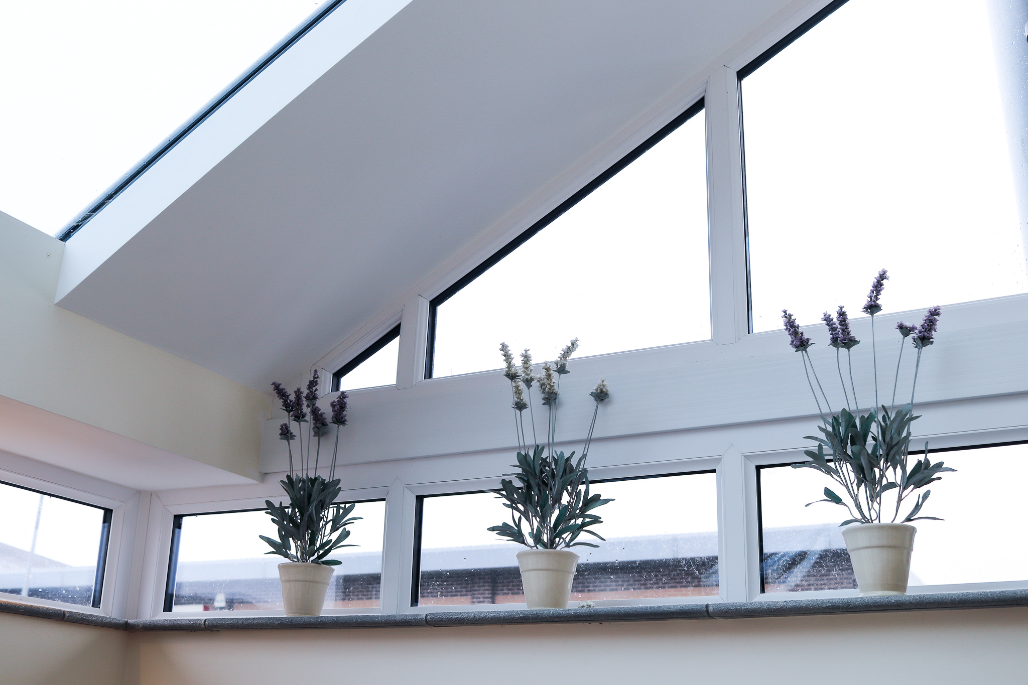 Image of flower pots on top of new window installation.