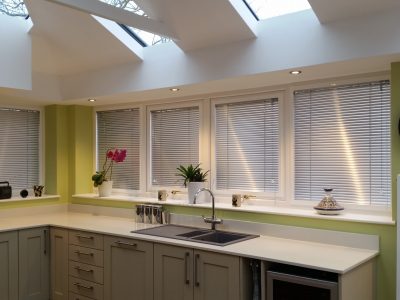 Green kitchen design with lovely luminous Livin room roof design.